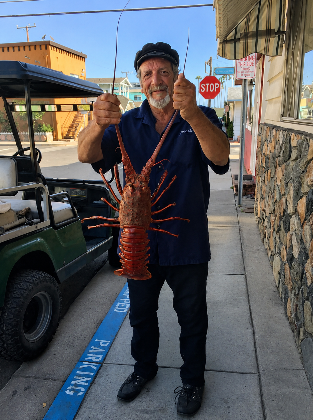 Roger holding a fresh-caught lobster on the streets of Avalon
